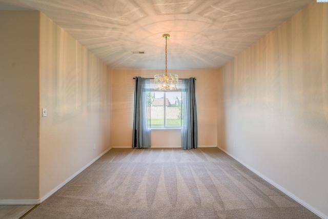 927 N Owen Ave, Pasco, WA 99301 - unfurnished dining area featuring a chandelier, light carpet, and baseboards