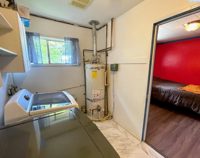 2402 Dover St, Richland, WA 99352 - laundry room with water heater, washer and dryer, and light marble finish flooring