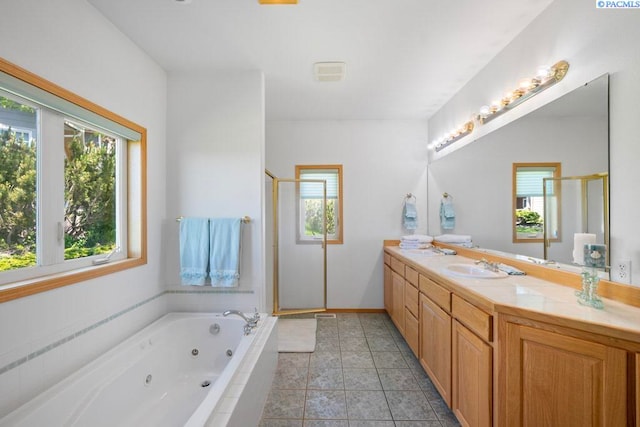 1815 NW Nicole Ct, Pullman, WA 99163 - bathroom featuring a shower stall, vanity, a jetted tub, and tile patterned floors