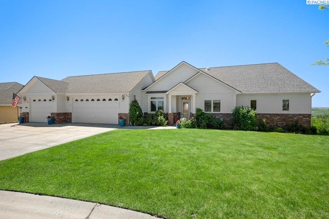 1815 NW Nicole Ct, Pullman, WA 99163 - view of front facade with an attached garage, brick siding, a front yard, and driveway