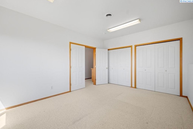 1815 NW Nicole Ct, Pullman, WA 99163 - unfurnished bedroom with two closets, baseboards, and light carpet