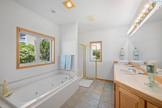 1815 NW Nicole Ct, Pullman, WA 99163 - bathroom with double vanity, a tub with jets, a shower stall, tile patterned floors, and baseboards