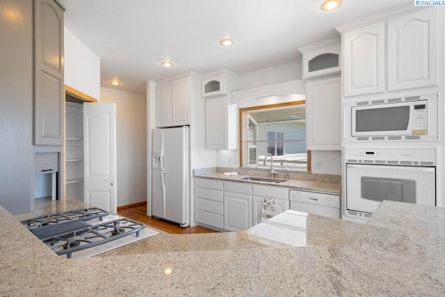 1815 NW Nicole Ct, Pullman, WA 99163 - kitchen featuring white appliances, a sink, glass insert cabinets, light stone counters, and white cabinetry