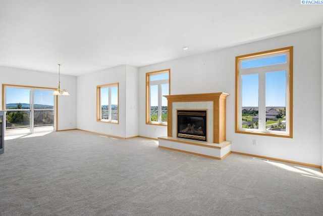 1815 NW Nicole Ct, Pullman, WA 99163 - unfurnished living room featuring carpet floors, baseboards, and a glass covered fireplace