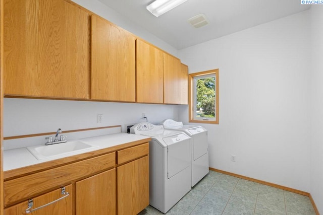 1815 NW Nicole Ct, Pullman, WA 99163 - laundry area with cabinet space, washer and clothes dryer, baseboards, and light tile patterned flooring
