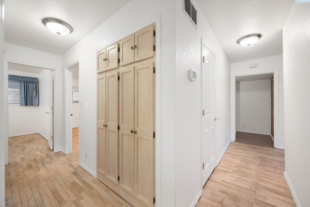 corridor featuring light hardwood / wood-style flooring