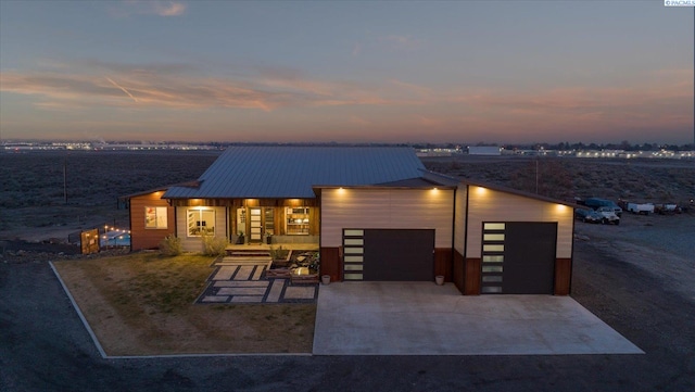 contemporary house featuring a porch and a garage