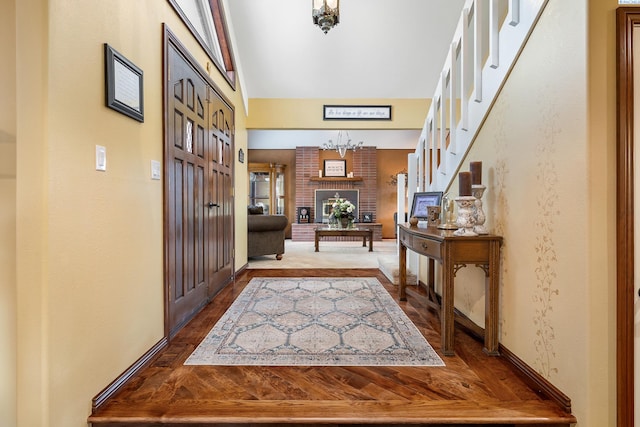 4834 W Robin Ct, West Richland, WA 99353 - entrance foyer with wood finished floors, a chandelier, vaulted ceiling, and stairs