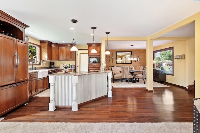 4834 W Robin Ct, West Richland, WA 99353 - kitchen featuring dark wood-type flooring, recessed lighting, brown cabinets, pendant lighting, and black appliances