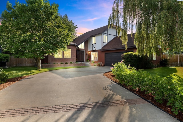 4834 W Robin Ct, West Richland, WA 99353 - english style home with concrete driveway, an attached garage, brick siding, and stucco siding