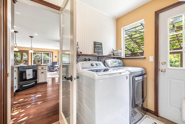 4834 W Robin Ct, West Richland, WA 99353 - laundry room with washing machine and dryer, wood finished floors, and healthy amount of natural light