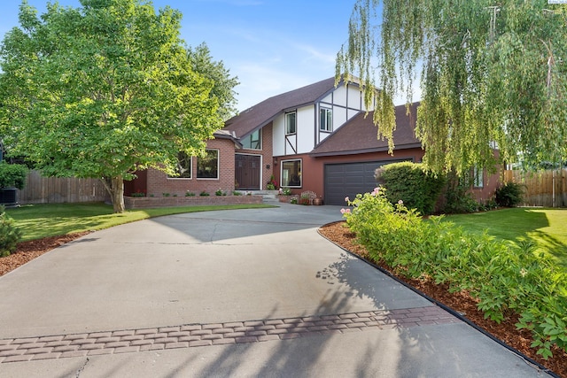 4834 W Robin Ct, West Richland, WA 99353 - english style home with driveway, a garage, stucco siding, brick siding, and a shingled roof