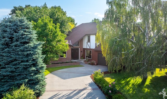 4834 W Robin Ct, West Richland, WA 99353 - view of front of house featuring concrete driveway, an attached garage, brick siding, and a shingled roof