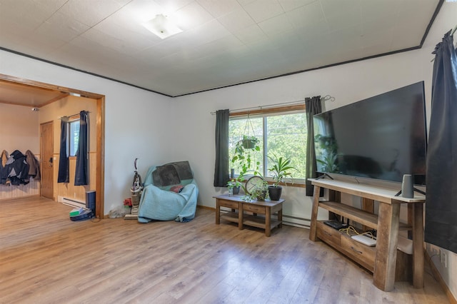 sitting room with wood finished floors and a baseboard radiator