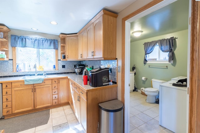 kitchen featuring open shelves, a sink, light tile patterned flooring, washer / clothes dryer, and recessed lighting