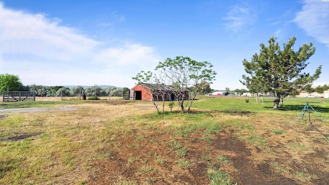 view of yard with fence and an outdoor structure