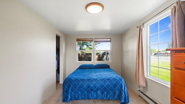 carpeted bedroom featuring a baseboard radiator