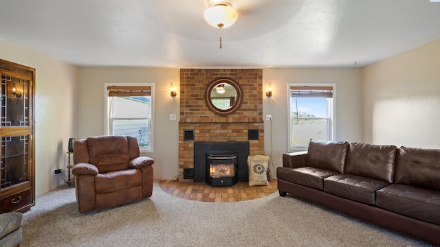living area with a brick fireplace, a wealth of natural light, and carpet