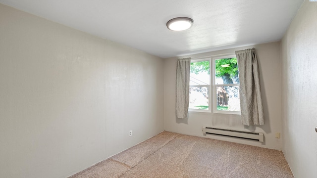 carpeted empty room with baseboard heating