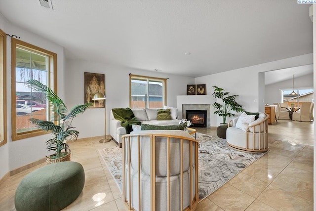 tiled living room with a wealth of natural light and a fireplace