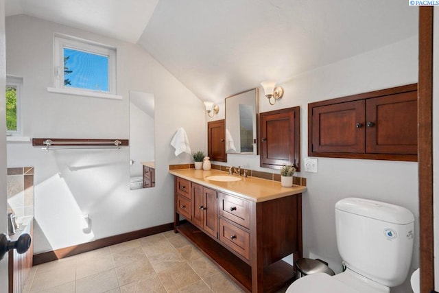 1005 NW State St, Pullman, WA 99163 - bathroom with lofted ceiling, vanity, toilet, and baseboards