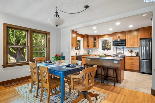 1005 NW State St, Pullman, WA 99163 - dining room featuring plenty of natural light, recessed lighting, light wood-style floors, and baseboards