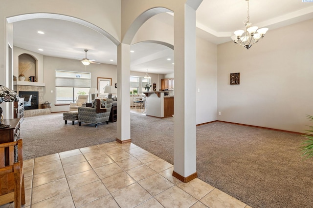 8712 W 9th Ave, Kennewick, WA 99336 - foyer featuring light colored carpet, arched walkways, a tile fireplace, recessed lighting, and a chandelier