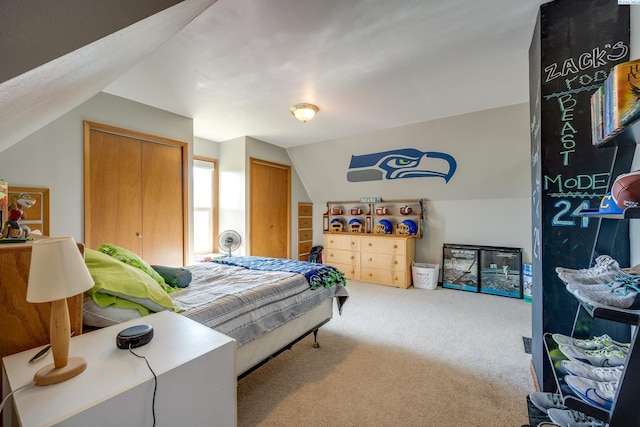 carpeted bedroom with vaulted ceiling