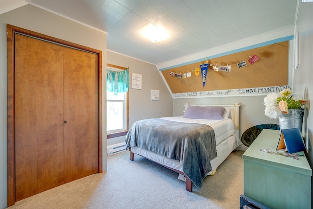 bedroom featuring a closet, carpet floors, baseboard heating, and lofted ceiling