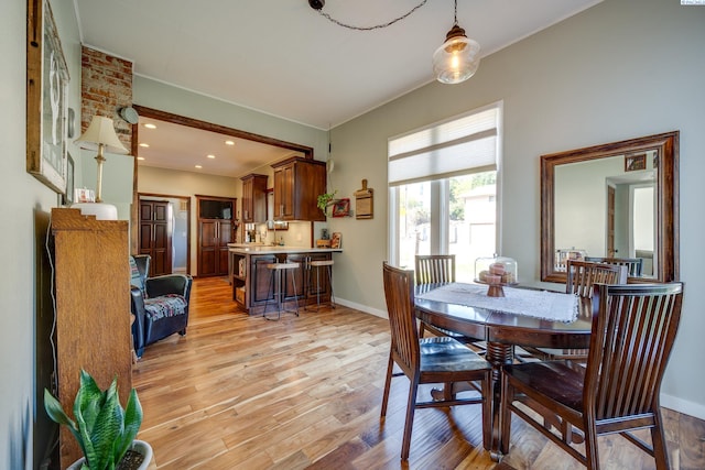 dining area featuring recessed lighting, baseboards, and light wood-type flooring