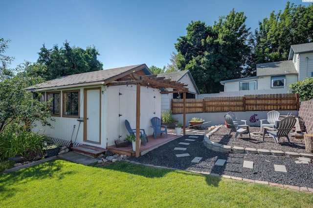 exterior space featuring a fire pit, an outdoor structure, and fence