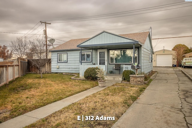 view of front facade with a garage, an outdoor structure, and a front yard
