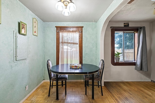 506 S Zillah St, Kennewick, WA 99336 - dining room with healthy amount of natural light, arched walkways, baseboards, and a chandelier
