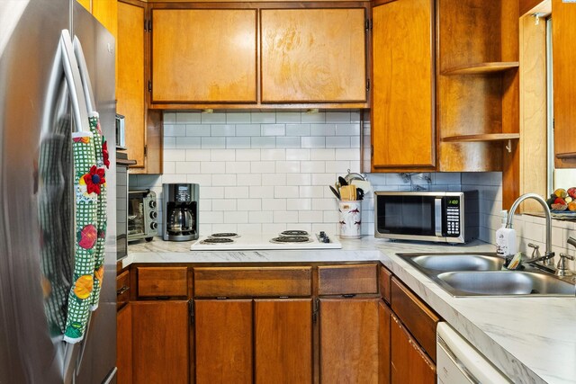 506 S Zillah St, Kennewick, WA 99336 - kitchen with stainless steel appliances, open shelves, a sink, light countertops, and tasteful backsplash