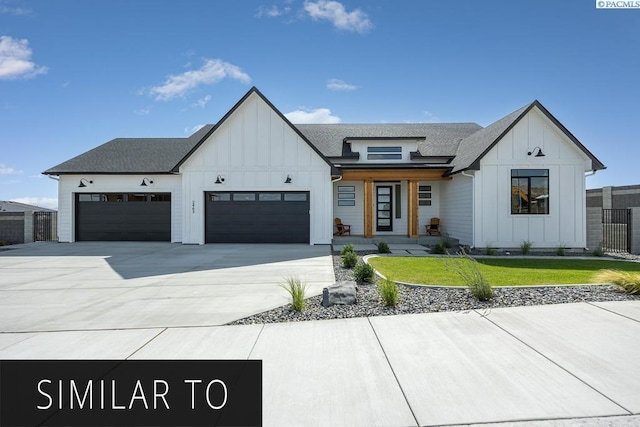 modern inspired farmhouse featuring a garage and a front yard