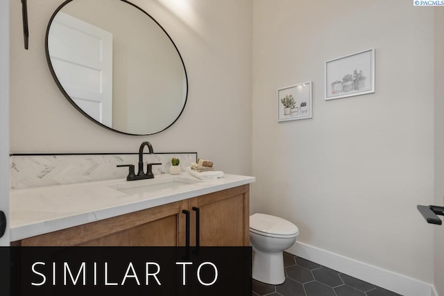 bathroom featuring vanity, toilet, and tile patterned flooring