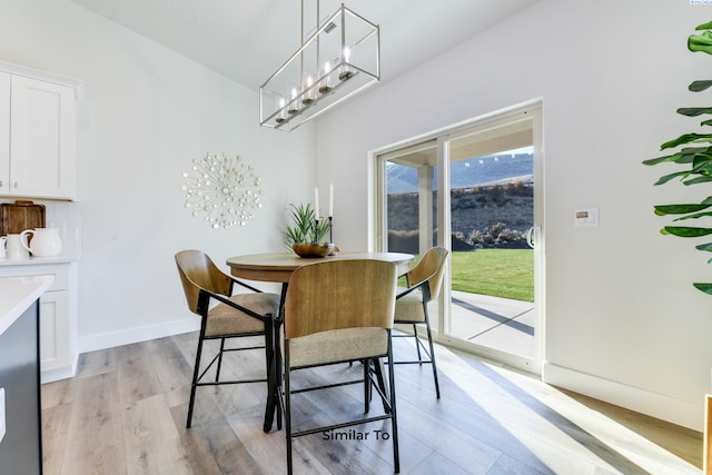6482 W 30th Pl, Kennewick, WA 99338 - dining room with light wood-type flooring, a chandelier, and baseboards