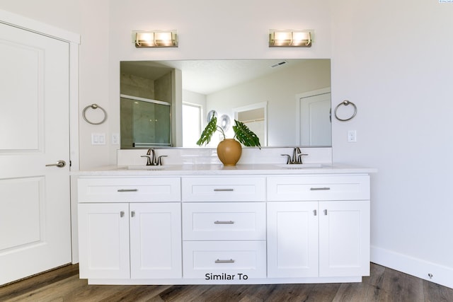 6482 W 30th Pl, Kennewick, WA 99338 - full bath featuring a shower stall, double vanity, wood finished floors, and baseboards