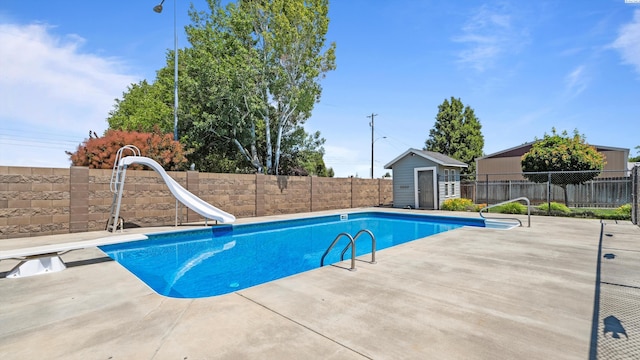 1824 W 28th Ave, Kennewick, WA 99337 - view of pool with a water slide, a fenced backyard, a patio, a diving board, and an outbuilding