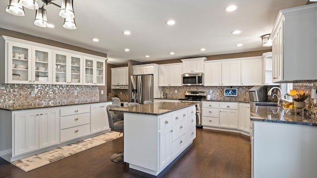 1824 W 28th Ave, Kennewick, WA 99337 - kitchen with stainless steel appliances, dark wood-type flooring, recessed lighting, a center island, and white cabinetry