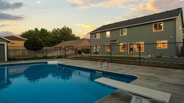 1824 W 28th Ave, Kennewick, WA 99337 - pool at dusk with a patio area and a diving board