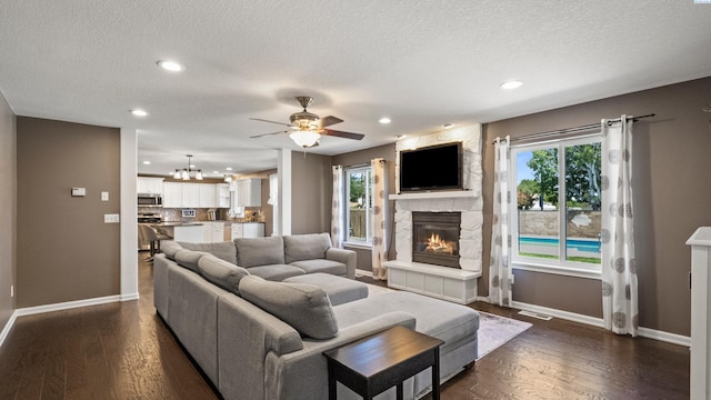 1824 W 28th Ave, Kennewick, WA 99337 - living area with a fireplace, a textured ceiling, a ceiling fan, recessed lighting, and plenty of natural light
