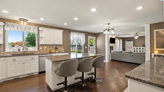 1824 W 28th Ave, Kennewick, WA 99337 - kitchen with dishwasher, tasteful backsplash, a center island, dark wood-style flooring, and recessed lighting