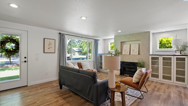 654 Cottonwood Dr, Richland, WA 99352 - living area with wood finished floors, a fireplace, baseboards, and recessed lighting