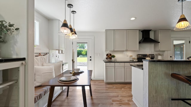654 Cottonwood Dr, Richland, WA 99352 - kitchen with wall chimney range hood, dark countertops, light wood-style floors, stainless steel electric stove, and recessed lighting