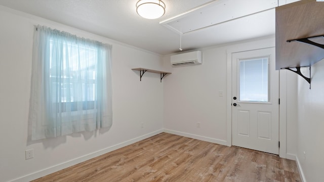 654 Cottonwood Dr, Richland, WA 99352 - empty room featuring attic access, an AC wall unit, light wood-style floors, and baseboards