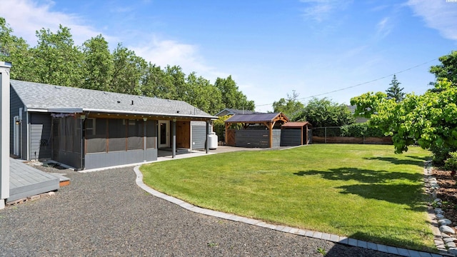 654 Cottonwood Dr, Richland, WA 99352 - view of yard featuring a sunroom, a detached garage, and an outdoor structure