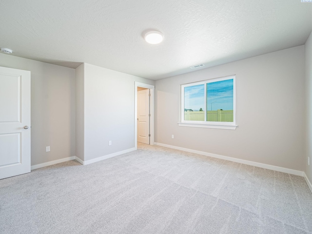 1600 SW Kelandren Dr, Prosser, WA 99350 - unfurnished bedroom with baseboards, light carpet, and a textured ceiling