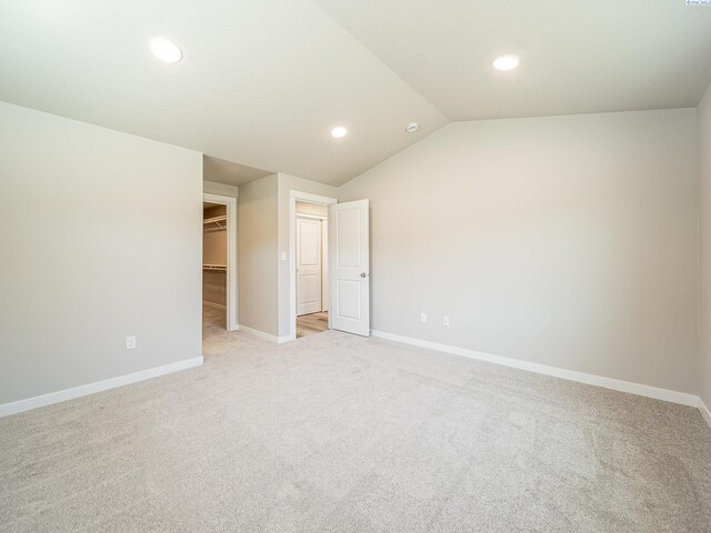 1600 SW Kelandren Dr, Prosser, WA 99350 - unfurnished bedroom with baseboards, light carpet, recessed lighting, lofted ceiling, and a walk in closet