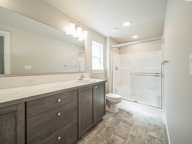 1600 SW Kelandren Dr, Prosser, WA 99350 - full bath featuring toilet, a stall shower, vanity, and stone finish floors